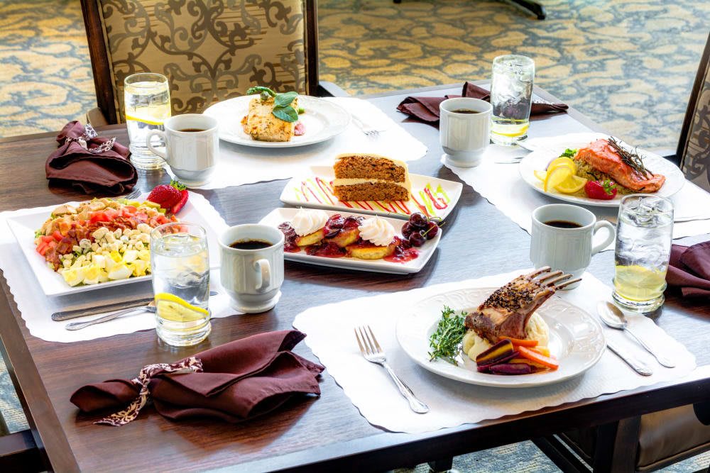 A table set with a variety of meals and drinks, ready for dining.