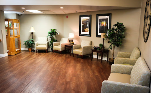 A cozy waiting room with soft seating and decorative elements.