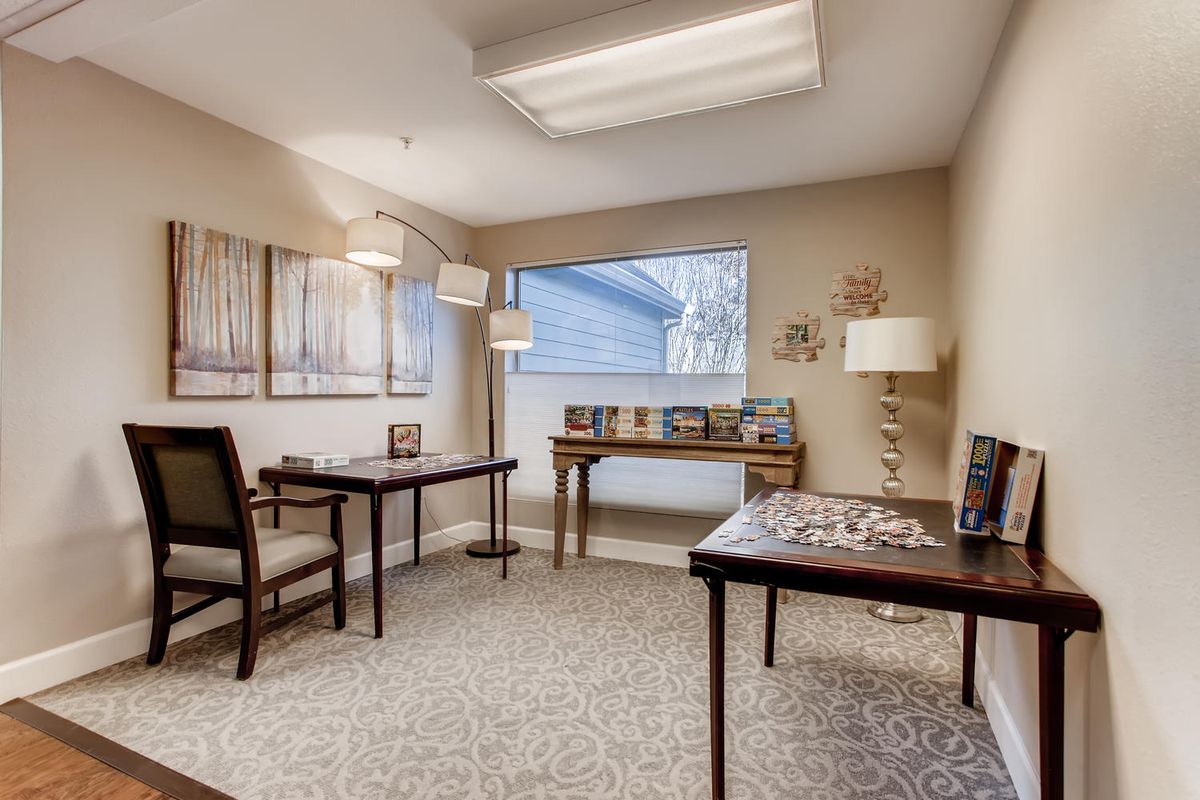 A neatly arranged office space with desks, chairs, and decorative elements.