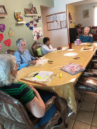 Seniors engaging in a creative activity at a community center.