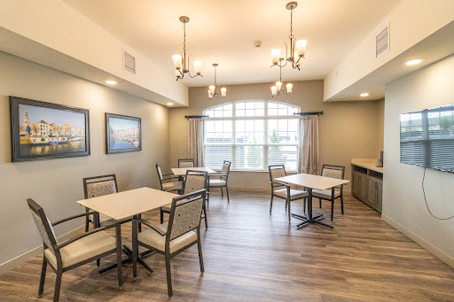 A modern dining area featuring elegant lighting and comfortable seating.