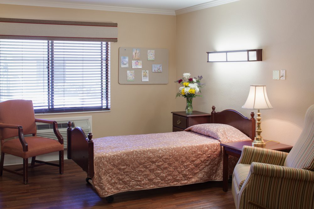 A cozy and neatly arranged bedroom with a single bed, soft lighting, and tasteful decor.