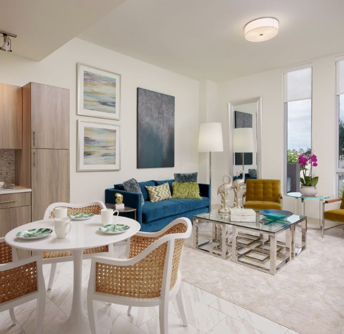 A modern living room with a cozy seating area and a small dining table.