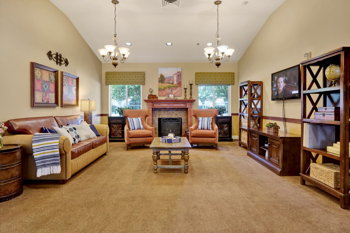 A cozy living room featuring a warm fireplace, comfortable sofas, and elegant lighting.