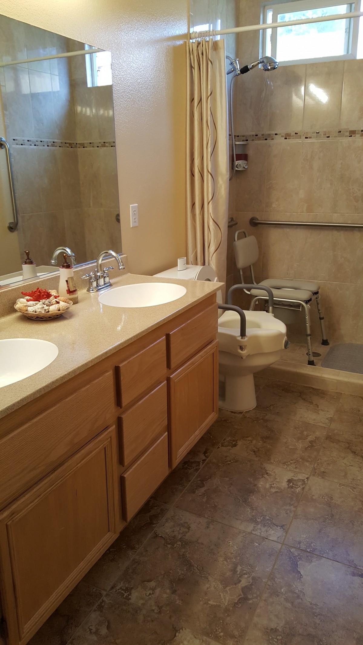 Accessible bathroom with double sinks and a walk-in shower.