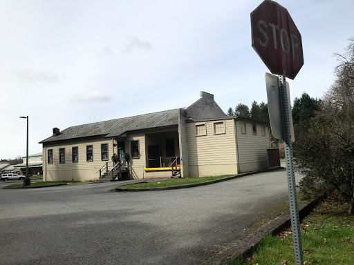 An interesting building with a stop sign in view, situated at a quiet intersection.