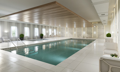 A serene indoor swimming pool featuring modern architecture and minimalist design.