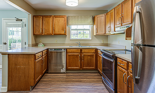 A traditional kitchen with wooden cabinets and modern appliances.