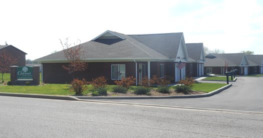 A suburban residential building with landscaped surroundings.