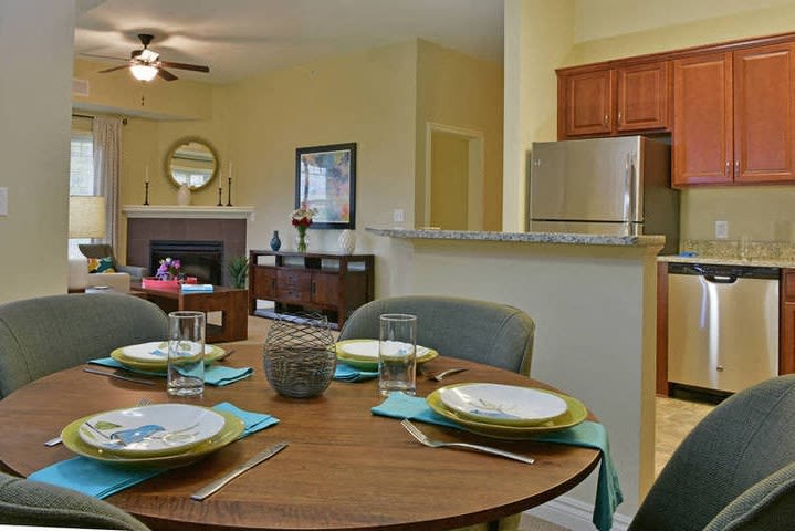 A cozy open-concept apartment with a dining area, living room, and kitchen.
