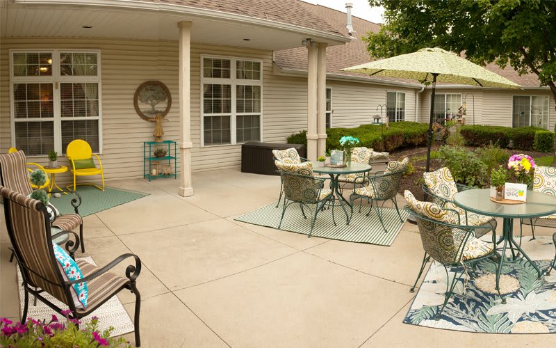 A cozy outdoor patio with seating and an umbrella, perfect for relaxation.