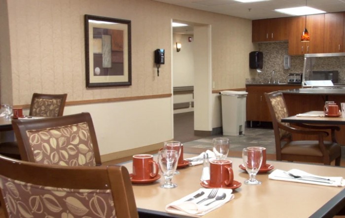 An indoor dining area with neatly arranged table settings, including cups and saucers.