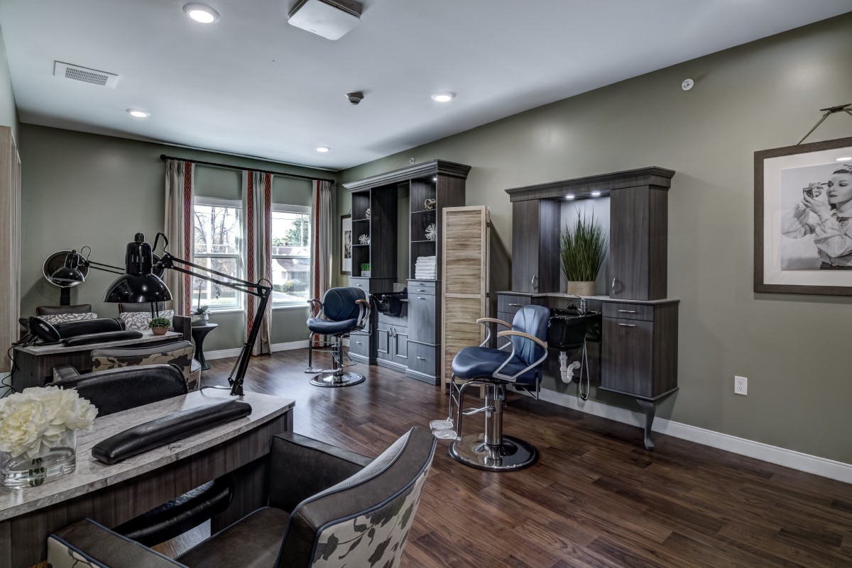Modern home office with stylish furniture and large windows.