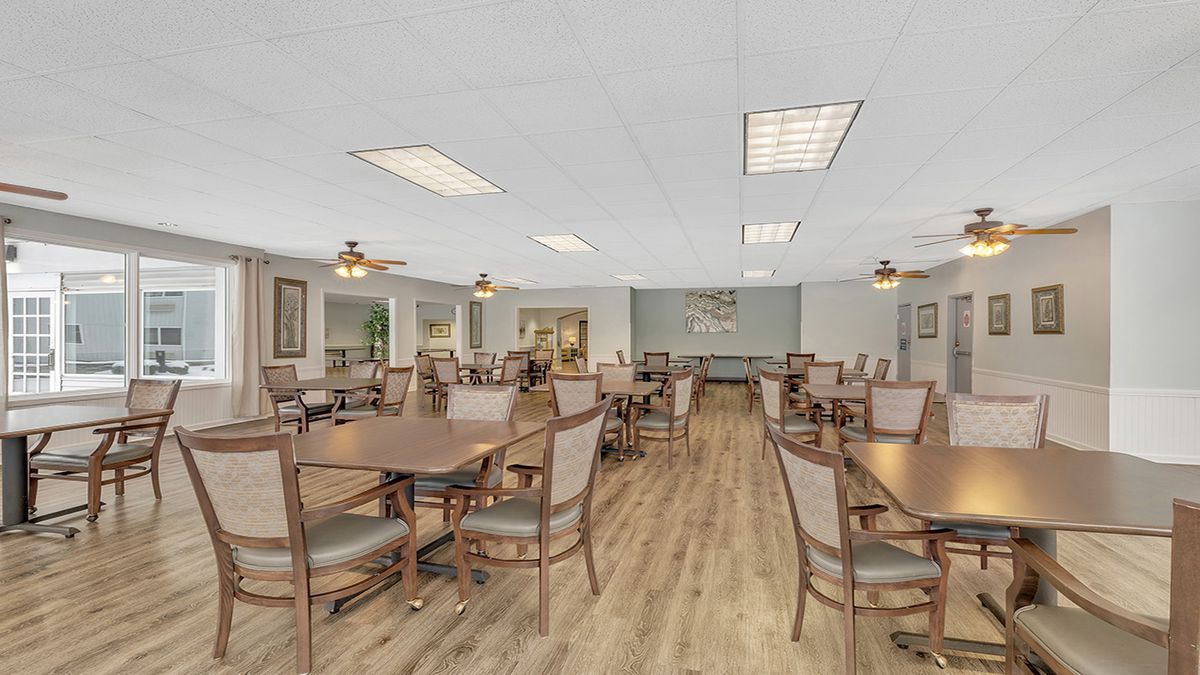 Spacious dining area with multiple tables and chairs, featuring a modern interior design.