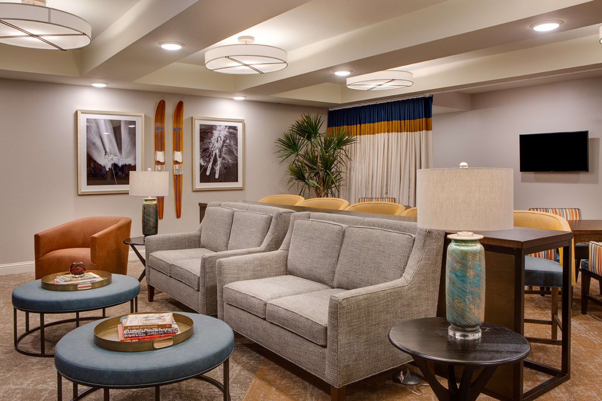 A well-decorated modern living room featuring cozy sofas, elegant artwork, and stylish furnishings.