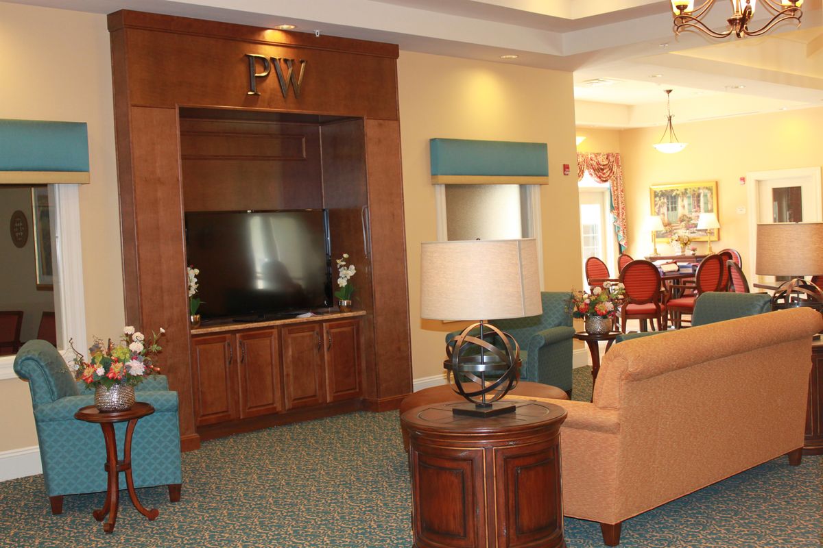 A cozy living room with comfortable seating and a large television.