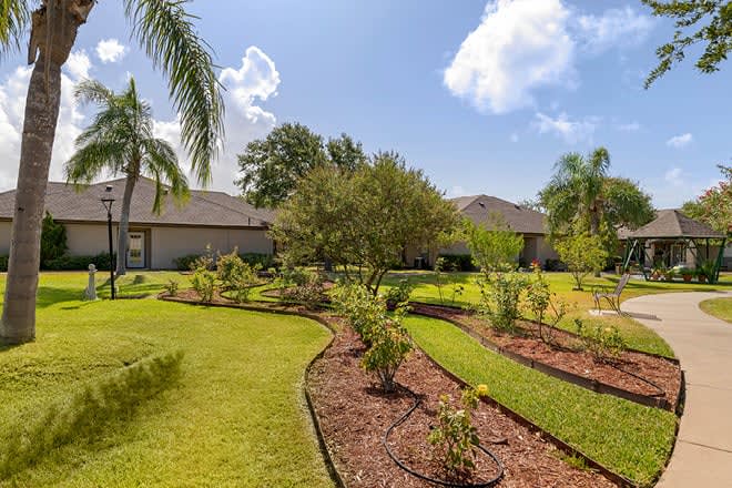 A beautifully landscaped garden with lush greenery under a sunny sky.