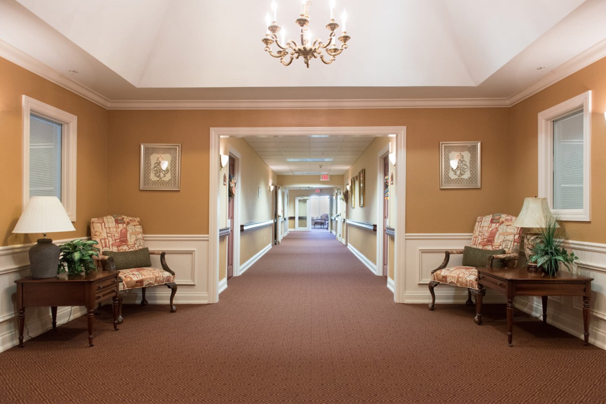 A well-lit hallway with elegant decor and comfortable seating.
