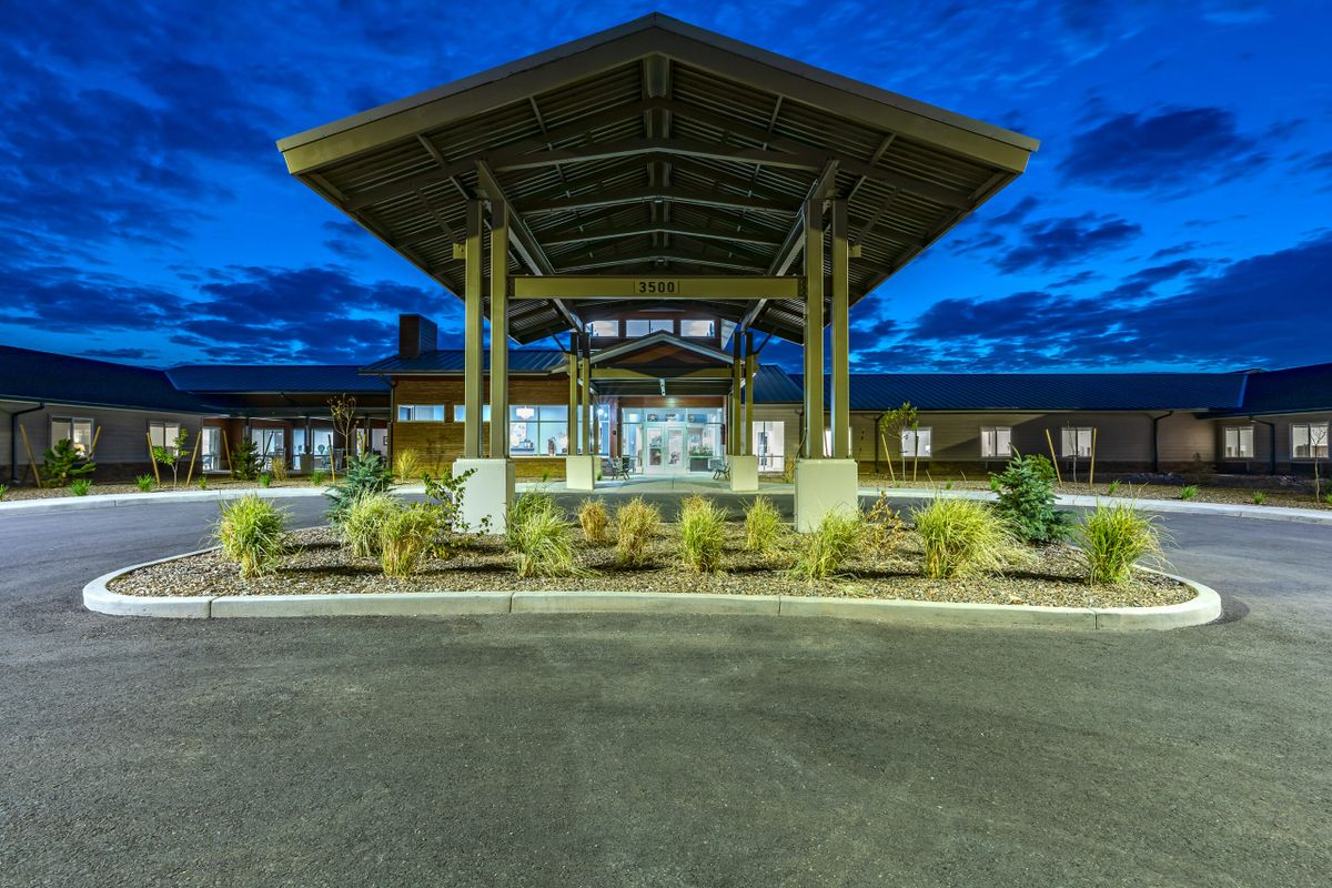 A well-lit building entrance with modern architecture at night.