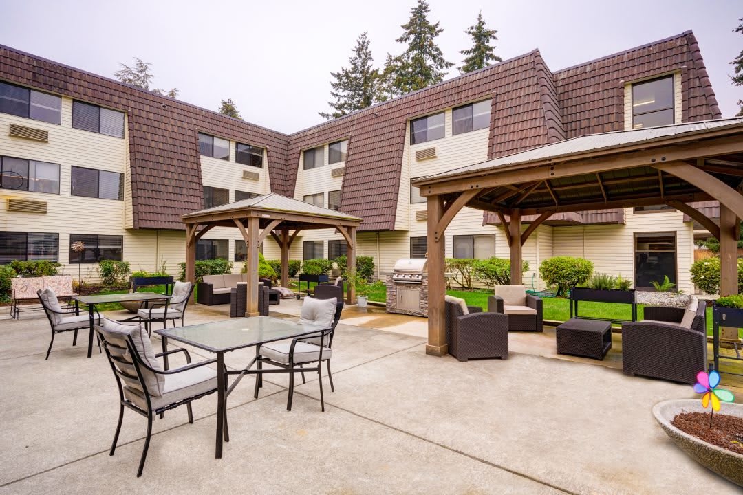 A residential courtyard with outdoor seating and gazebos.