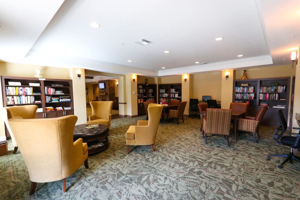 A cozy lounge area with armchairs and bookshelves.