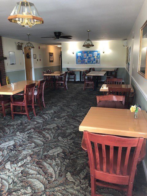 An empty restaurant interior with arranged tables and chairs.