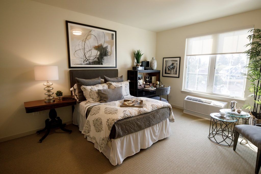 A cozy and modern bedroom with elegant decor and natural lighting.