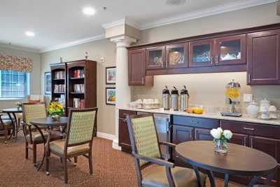 A cozy indoor reading area with bookshelves and a coffee station.