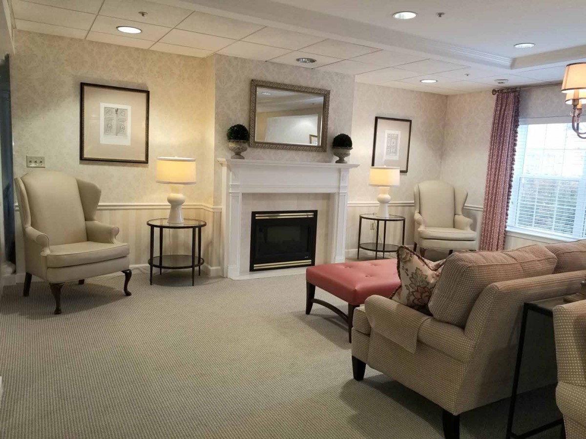 A cozy living room with comfortable seating around a fireplace.