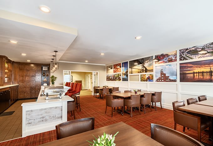 A modern restaurant interior featuring comfortable seating and wall art.
