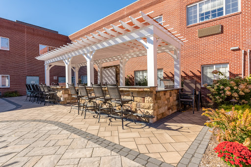 A cozy outdoor seating area featuring a pergola and comfortable furniture, perfect for relaxation.