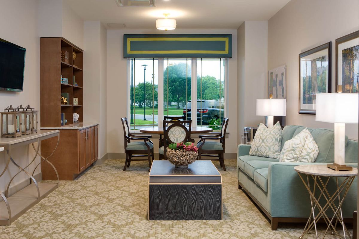 A cozy living room with a sofa, coffee table, and a window view.