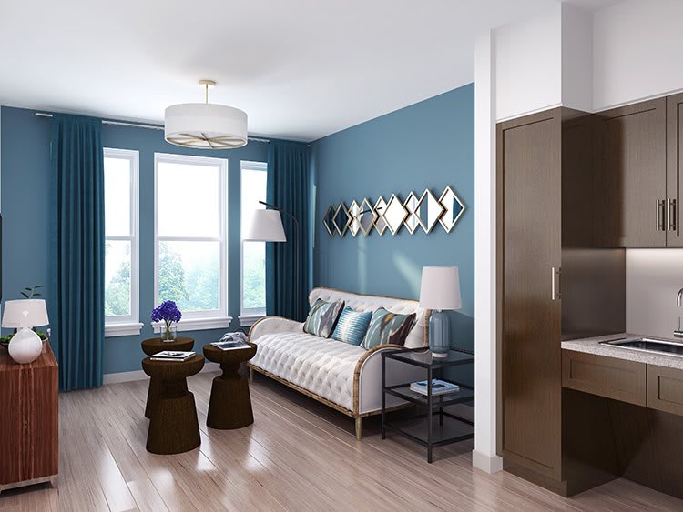 A modern living room with blue walls, stylish furniture, and natural light.