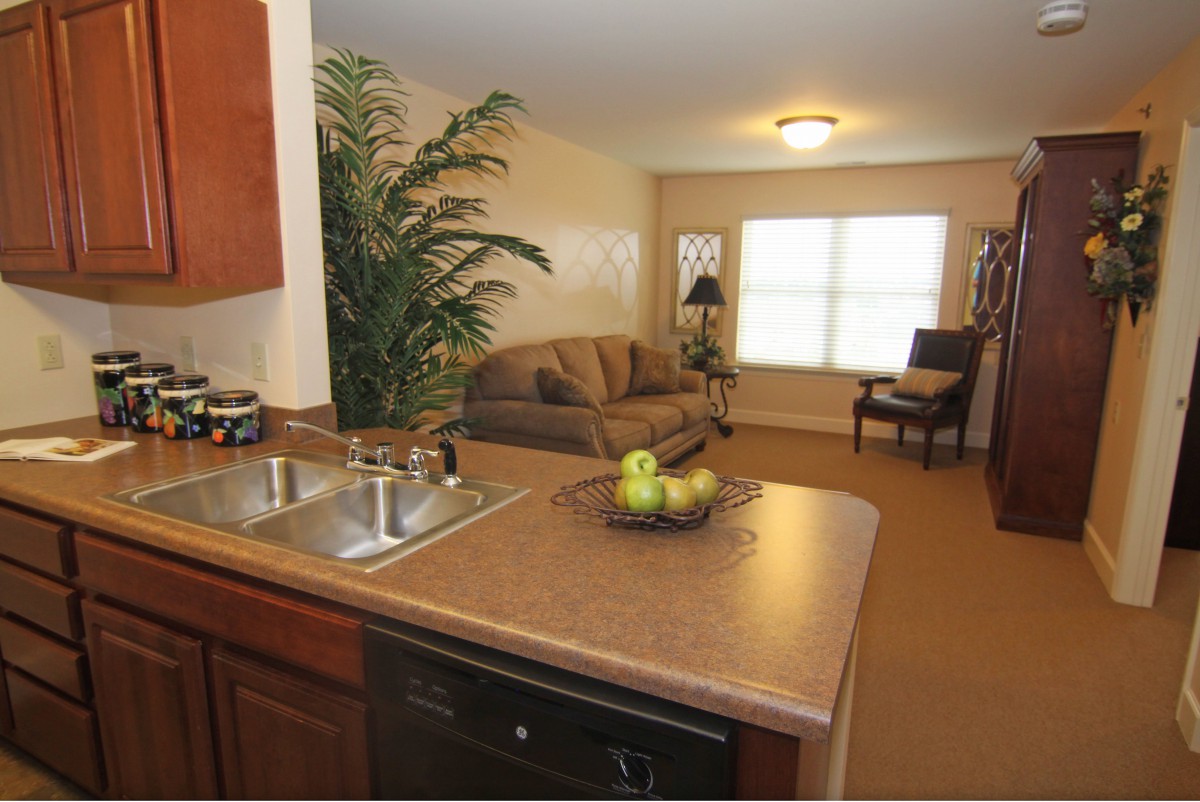 An open-plan kitchen and living room with modern furnishings and decor.