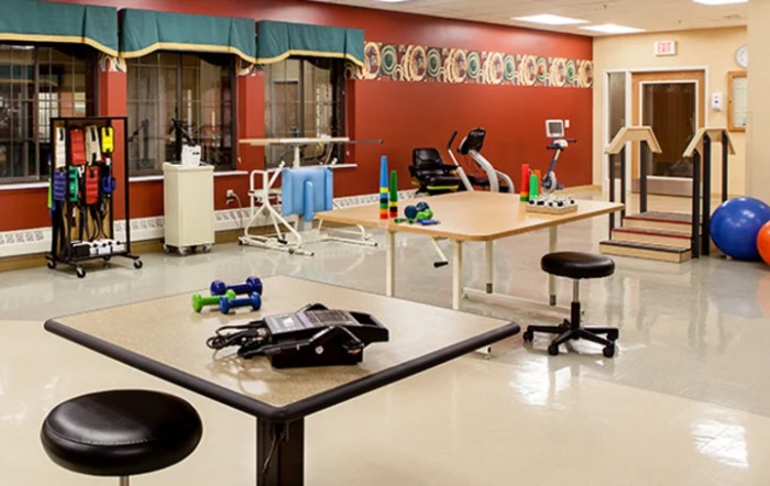 A physical therapy and rehabilitation room equipped with various exercise devices.