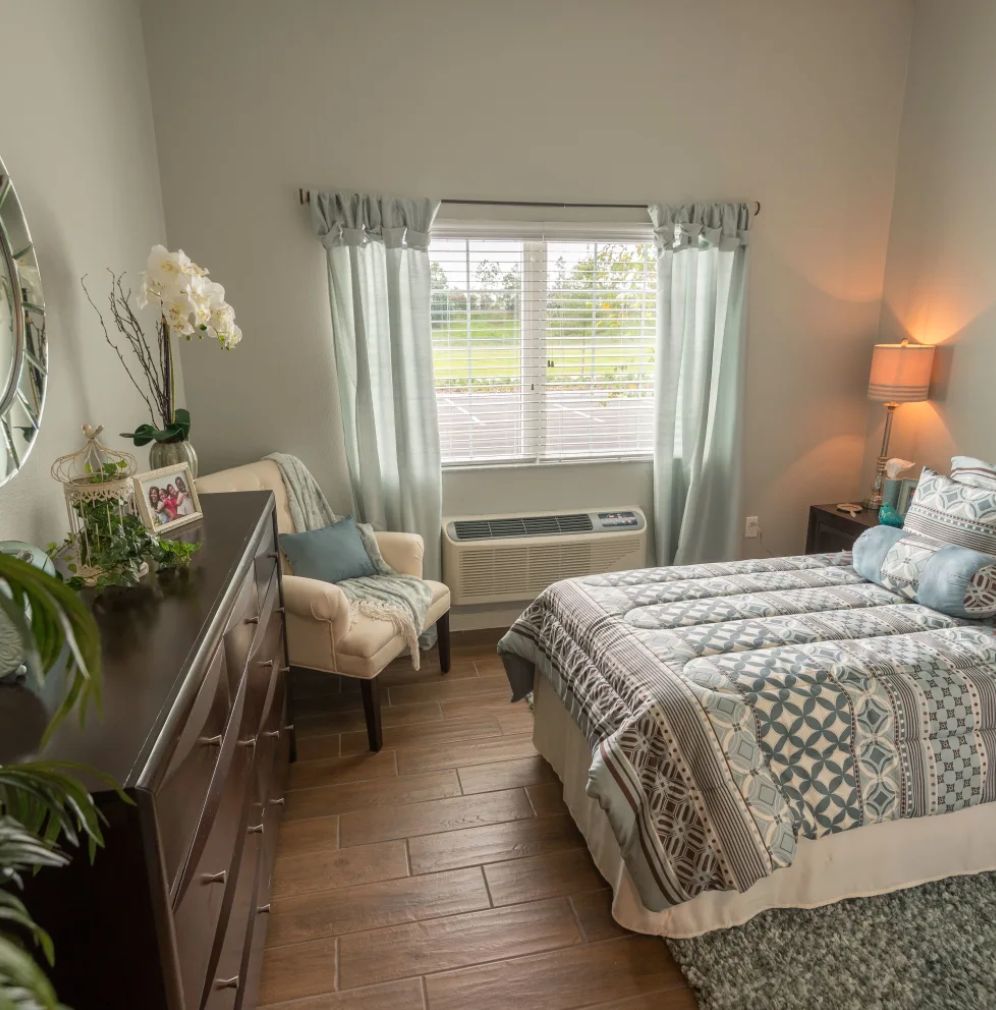 A cozy bedroom with a neatly made bed, soft lighting, and elegant decor.