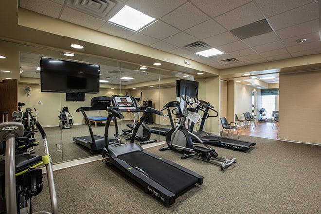 A well-equipped gym with treadmills and exercise machines.