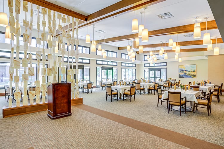Spacious and elegantly designed dining area with modern lighting and furnishings.