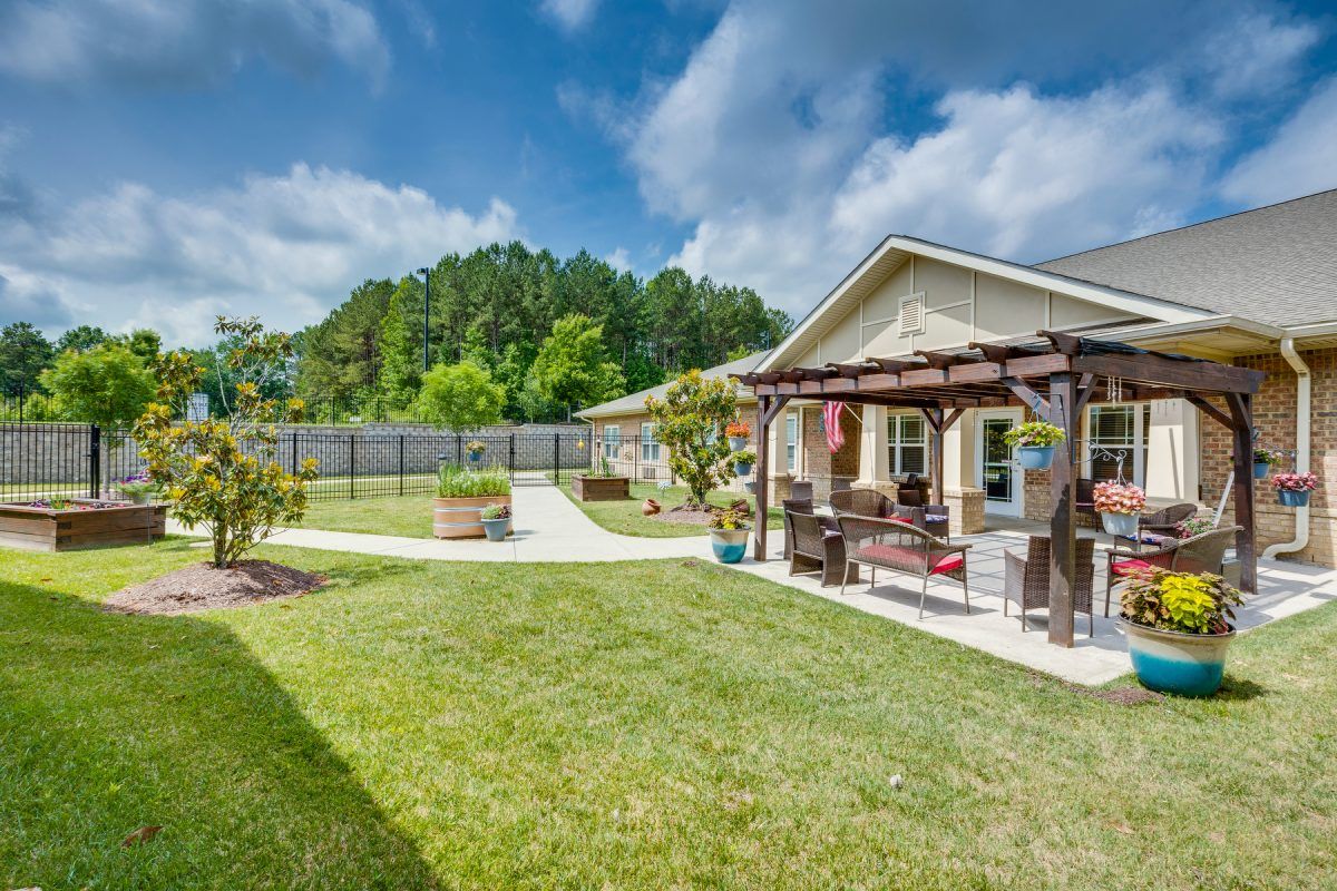 A beautiful backyard with a pergola and well-maintained lawn, perfect for outdoor relaxation.