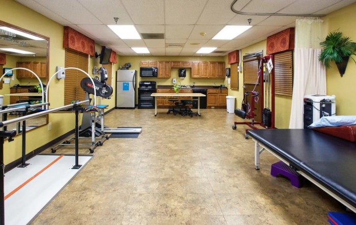 A spacious gym room equipped with various exercise machines and equipment for workouts.