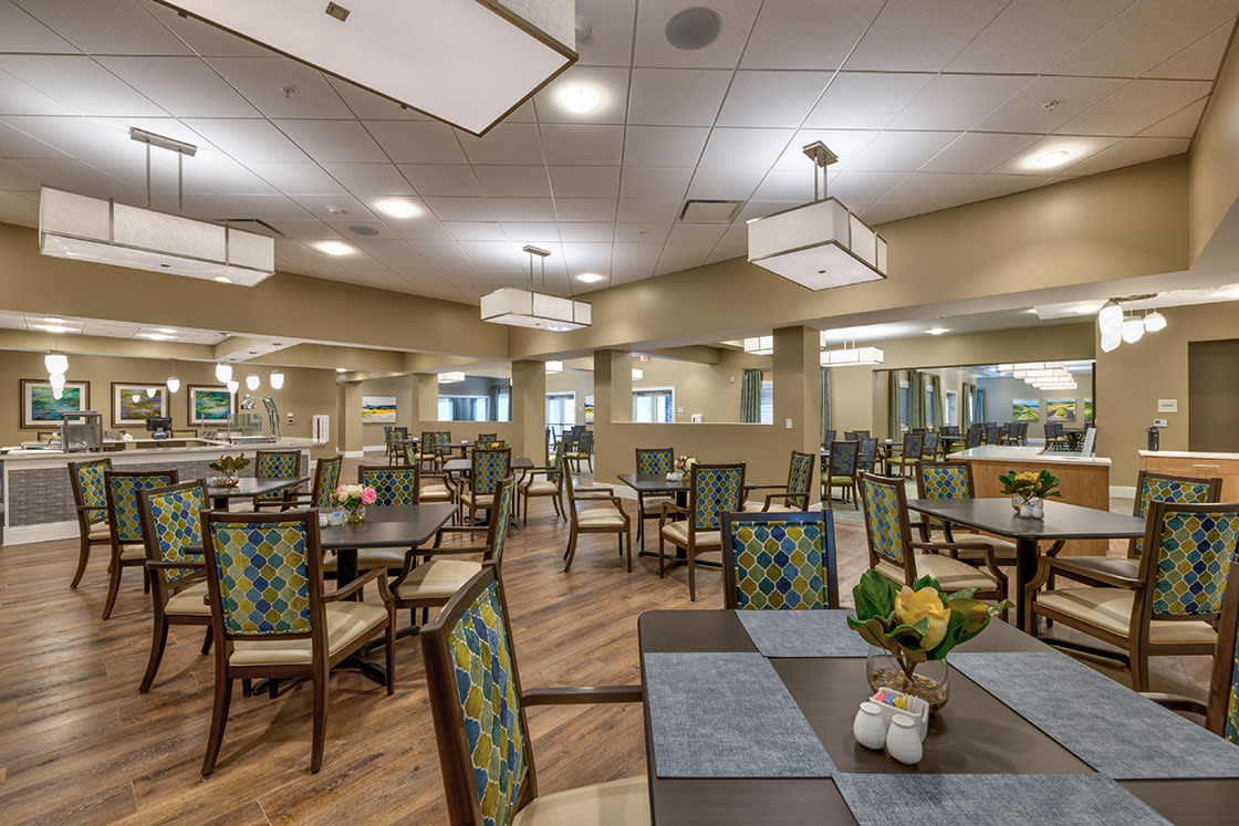 A spacious dining room featuring modern decor and well-arranged tables and chairs.