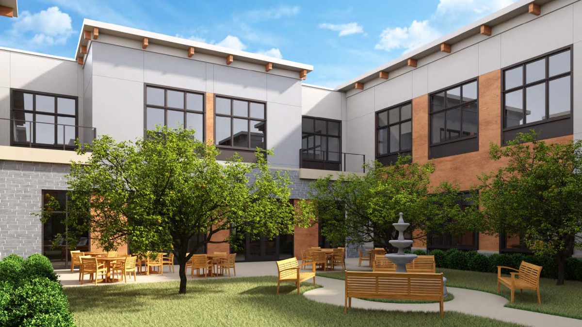 A peaceful courtyard with outdoor seating and a central fountain, surrounded by lush greenery and modern building exteriors.