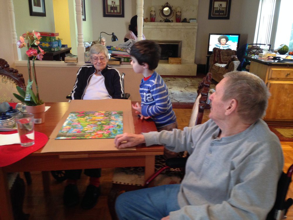 A family enjoying a board game together in the living room.