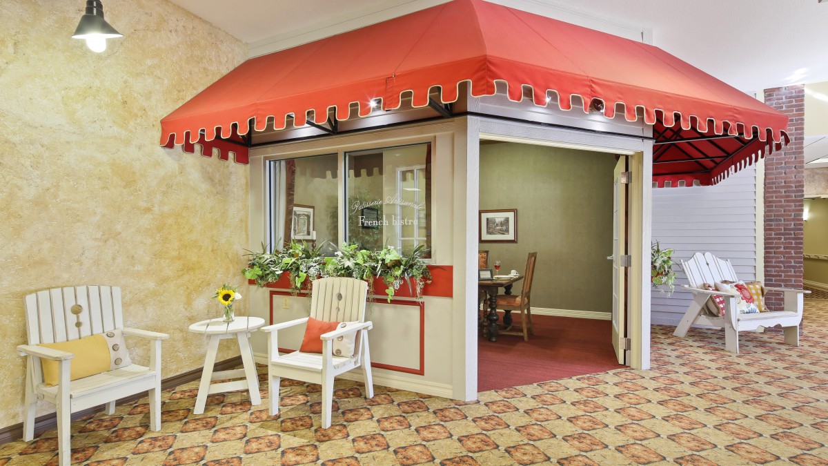A quaint indoor setting with a vintage-style storefront, featuring a red awning and charming decor.