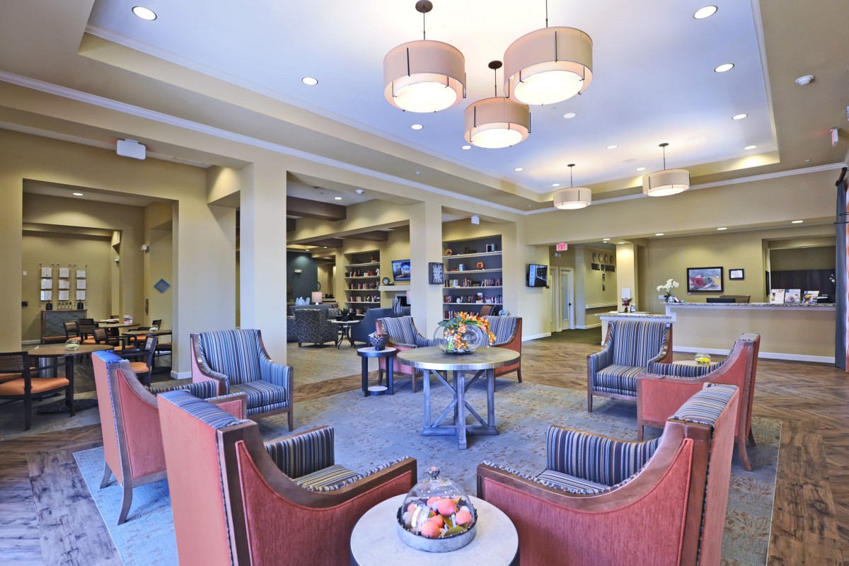 A modern lobby seating area with comfortable chairs and stylish lighting.