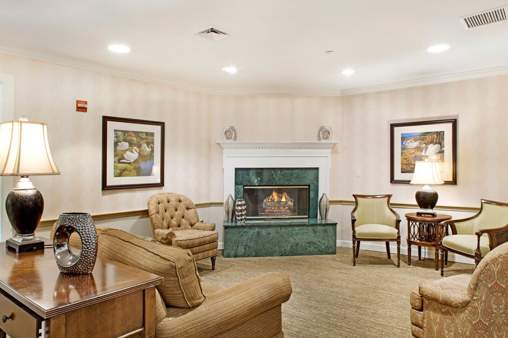 A cozy living room with a fireplace and comfortable seating.