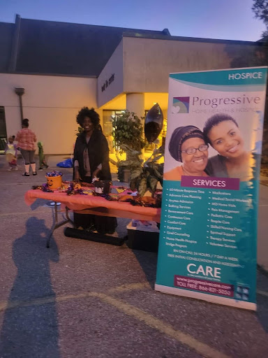 A community event booth showcasing various services with a promotional banner.