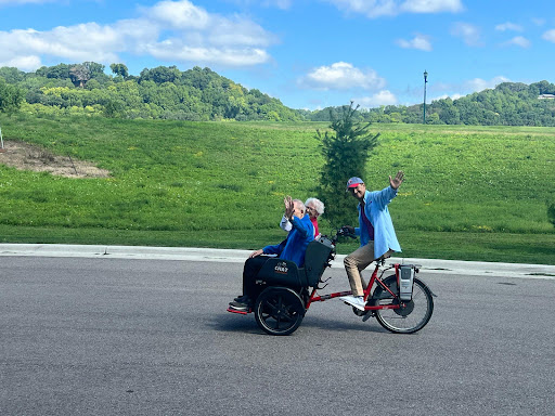 Two friends enjoying a ride on a bicycle in a scenic outdoor setting.