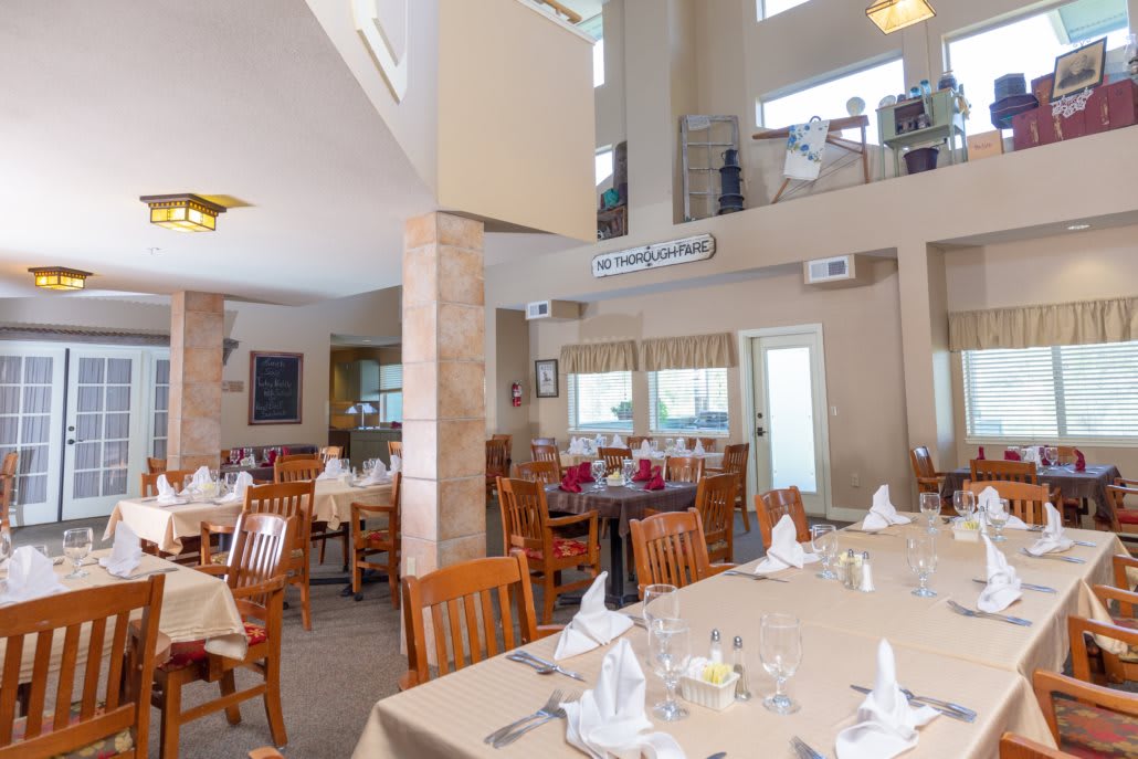 Interior view of a restaurant dining area with neatly set tables and chairs.