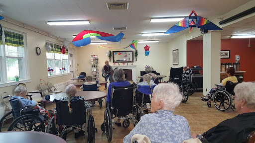 Residents enjoying a communal activity in a decorated nursing home.
